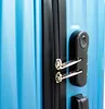 Close-up of a blue suitcase with a black zipper and a combination lock. Produktbild-Vorschau