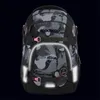 A backpack with a camouflage pattern and reflective elements. Produktbild-Vorschau