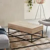 A living room setting with a coffee table on a rug, next to a sofa and a chair. Produktbild-Vorschau