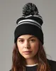 A woman wearing a striped beanie. Náhled obrázku produktu