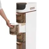 A hand is shown pulling out a drawer from a white storage cabinet with copper accents. Náhled obrázku produktu