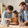 A family is baking together in a kitchen. Produktbild-Vorschau