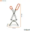 A pair of silver and orange grill tongs with measurement indicators. Podgląd zdjęcia produktu