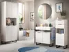 A modern bathroom with white vanity units, a bathtub, and a round mirror. Produktbild-Vorschau