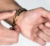 A person's hand is shown fastening a bracelet on their wrist. Produktbild-Vorschau