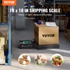A shipping scale in a warehouse setting with a box on it. Náhled obrázku produktu
