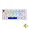A white mechanical keyboard with RGB lighting and a blue spacebar, shown from a top-down perspective. A small yellow object, possibly a switch, is visible in the bottom right corner. Produktbild-Vorschau