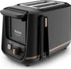A black Tefal Includeo toaster with bronze accents is shown against a white background. Voir les images du produit