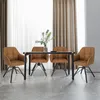 A dining set with four brown chairs and a black table, set against a backdrop of sheer and opaque curtains. Produktbild-Vorschau