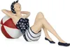 A decorative figurine of a woman in a vintage swimsuit relaxing on a beach ball. Anteprima dell’immagine prodotto