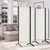 A cream-colored, 4-panel room divider is set up in a well-lit room with large windows and a sofa. Produktbild-Vorschau