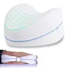 A white memory foam knee pillow with green grid pattern and blue zipper, shown in use between a person's legs. Anteprima dell’immagine prodotto