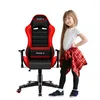 A young girl stands next to a red and black gaming chair. Náhled obrázku produktu
