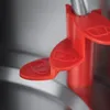 A close-up of a red lever with cup markings on a metallic surface. Produktbild-Vorschau