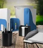 Office supplies on a wooden table with a blurred outdoor background. Náhľad obrázku produktu