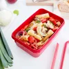 A red food container filled with pasta and vegetables. Produktbild-Vorschau