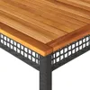 A close-up view of the corner of a table, showing the wooden tabletop and the woven rattan base. Produktbild-Vorschau