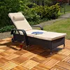 A chaise lounge chair sits on a wooden deck in a garden setting, with a drink and a book on it. Anteprima dell’immagine prodotto