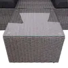 A close-up view of a grey rattan coffee table with a glass top, part of a lounge set. Produktbild-Vorschau