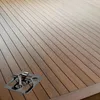 A metal fastening clip is shown on a wooden deck. Náhled obrázku produktu