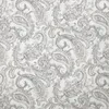 A close-up view of a fabric with a repeating paisley pattern. Produktbild-Vorschau