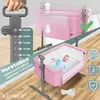 A pink baby crib with a baby inside, next to a height adjustment mechanism. Produktbild-Vorschau