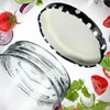 A jar lid and jar are shown with various salad ingredients floating around them. Produktbild-Vorschau