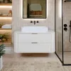 A modern bathroom with a white vanity, sink, and shower. Náhled obrázku produktu