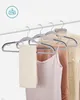 A set of gray hangers holding various clothing items. Náhled obrázku produktu