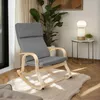 A rocking chair in a living room setting with a plant and a side table with a lamp. Náhled obrázku produktu