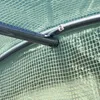Close-up of a metal frame covered by a green plastic sheeting, likely part of a greenhouse or tunnel. Anteprima dell’immagine prodotto