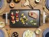 A table setting with a grill and food. Voir les images du produit