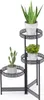 A black metal plant stand with three tiers, holding three different potted plants. Náhľad obrázku produktu