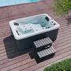 An outdoor whirlpool on a wooden deck next to a swimming pool. Náhled obrázku produktu