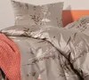 A close-up view of a bed with a floral patterned duvet and pillow, and a coral-colored throw blanket. Produktbild-Vorschau