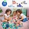 Three children are playing with wooden building blocks and a puzzle mat depicting a city. Náhled obrázku produktu