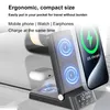 A black wireless charging station with a phone and earbuds on it, displaying charging indicators and a clock. Produktbild-Vorschau