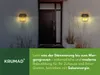 A modern house entrance with two solar-powered wall lights illuminating the facade and surrounding plants. Produktbild-Vorschau