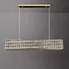 A rectangular crystal chandelier hanging from the ceiling against a gray wall. Náhľad obrázku produktu