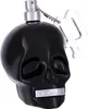 A black skull-shaped perfume bottle with a silver spray nozzle and a silver keychain attached. Náhľad obrázku produktu