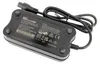 A black battery charger with cables attached, shown from a slightly elevated diagonal angle. Produktbild-Vorschau