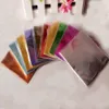 A fan of colorful candy wrappers laid out on a light-colored surface. Produktbild-Vorschau