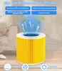 A yellow cylindrical air filter with blue and white accents, surrounded by a light gray and white background. Arrows and green leaves suggest air purification. Produktbild-Vorschau