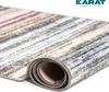A rolled-up rug with a striped pattern, on a white background. Náhled obrázku produktu