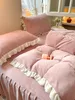 A close-up view of a pink bedding set with ruffled edges, neatly arranged on a bed. Produktbild-Vorschau