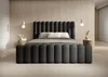 A modern bedroom with a dark gray upholstered bed as the focal point. Produktbild-Vorschau