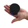 A hand holding a small black speaker. Produktbild-Vorschau