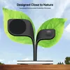 A product designed to look like a plant with leaves, featuring charging pads, set against a sky background and resting on a wooden surface. Podgląd zdjęcia produktu