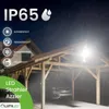 A wooden carport at night with a car parked inside, illuminated by a bright LED floodlight. Rain is falling. Náhled obrázku produktu