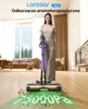 A woman is holding a cordless vacuum cleaner in a living room. Podgląd zdjęcia produktu